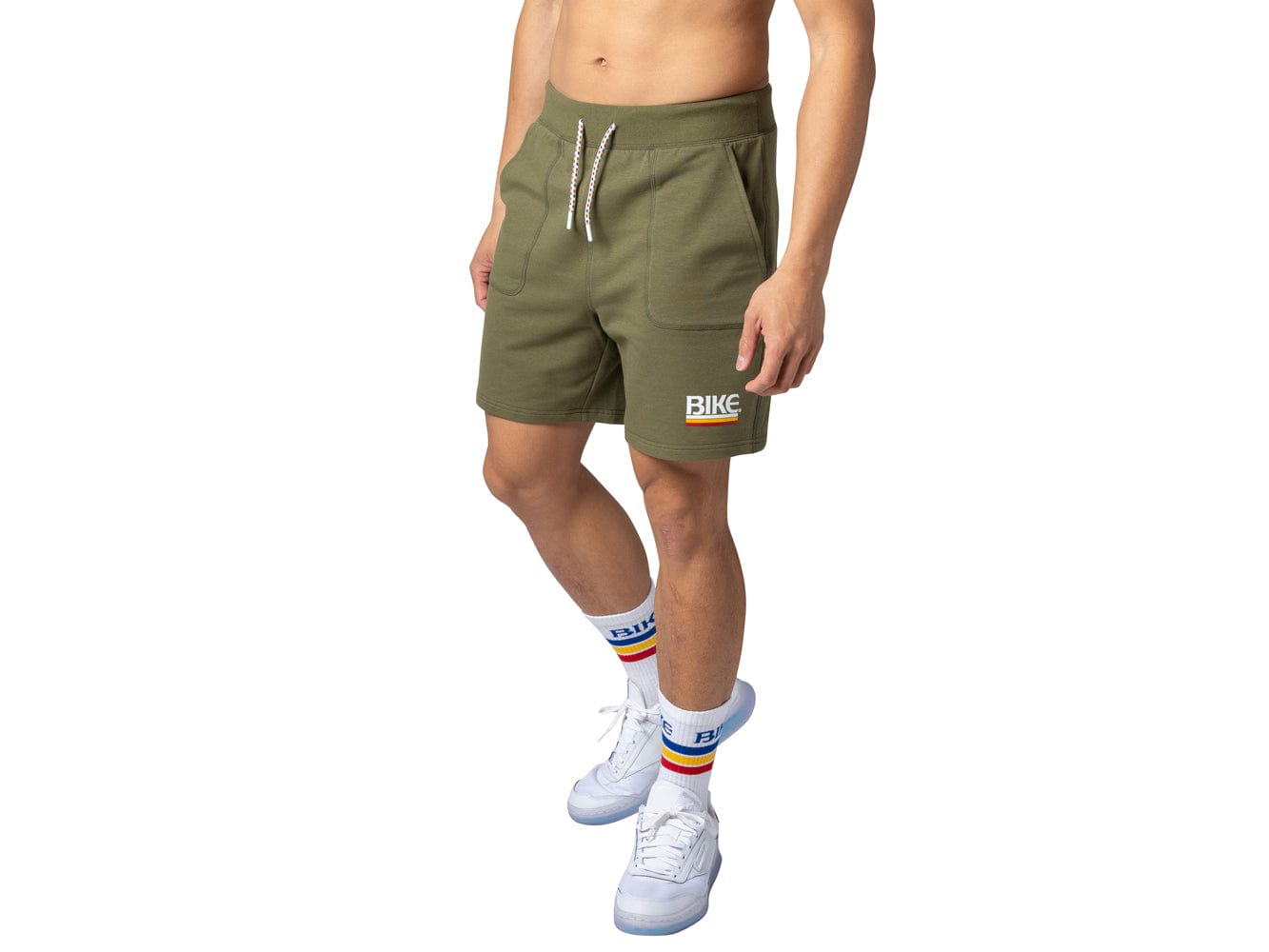 Man wearing olive BIKE® fleece shorts