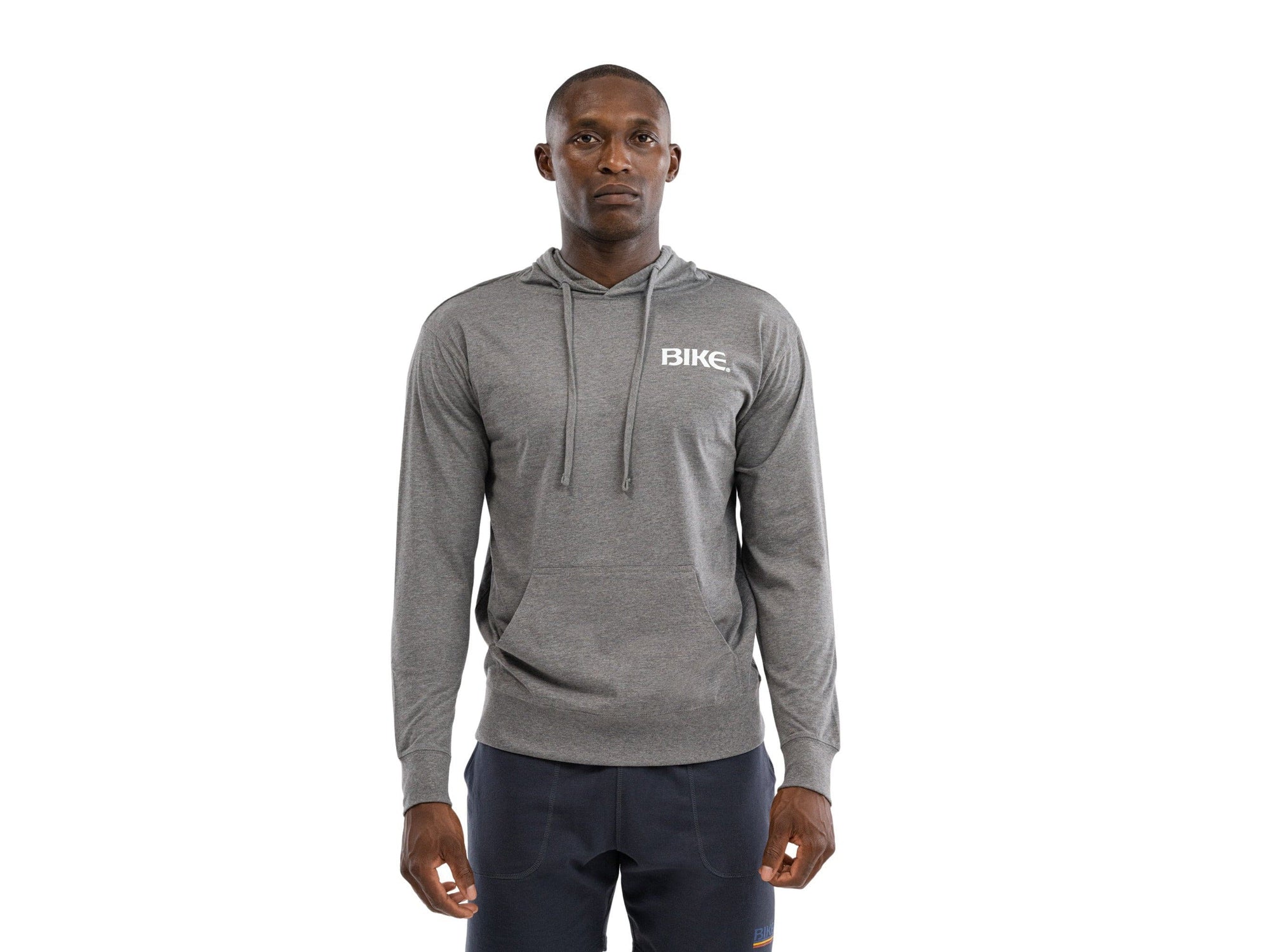 Man wearing lightweight grey BIKE® long sleeve hoodie