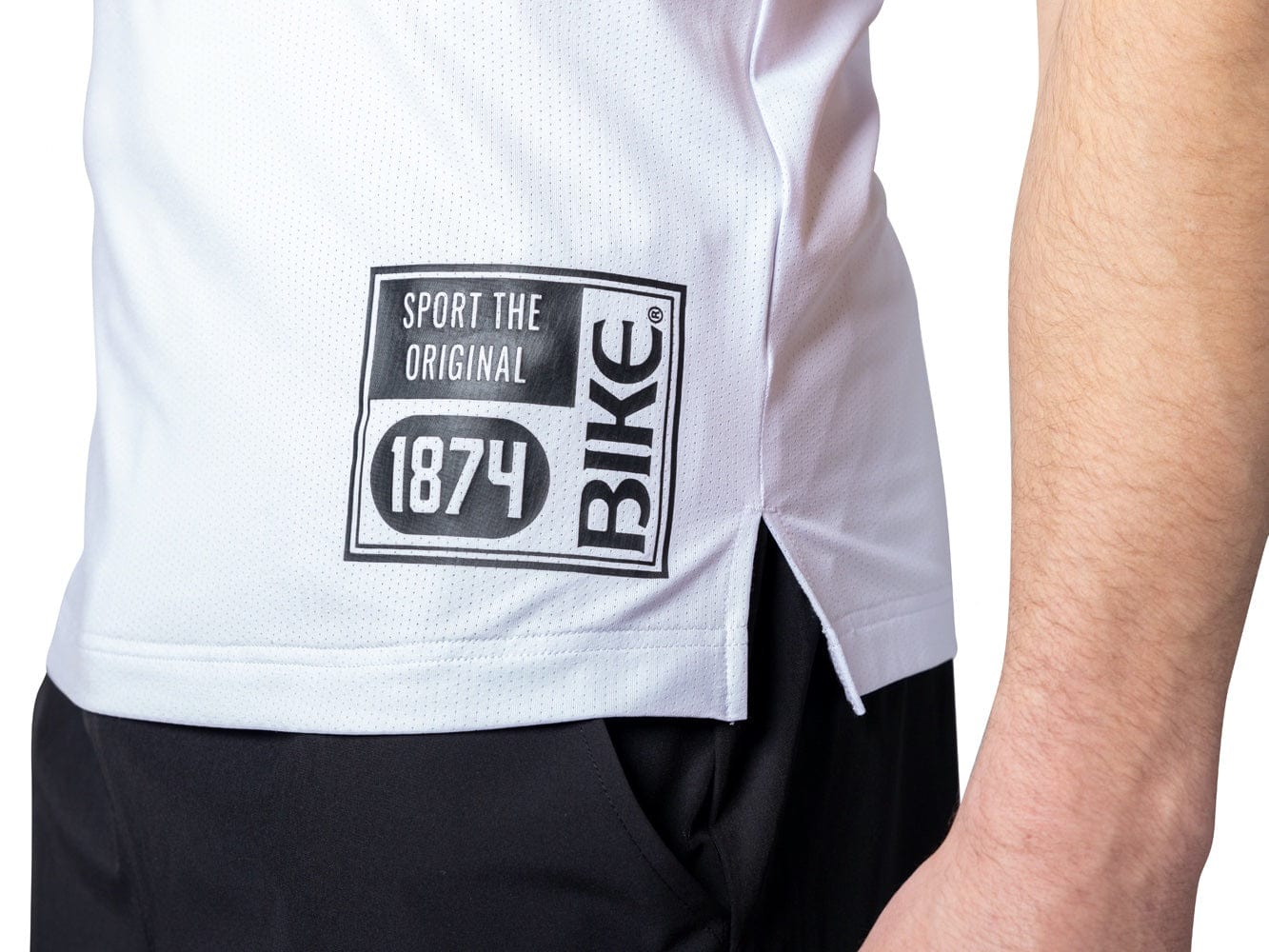 Man wearing white mesh BIKE® tank top