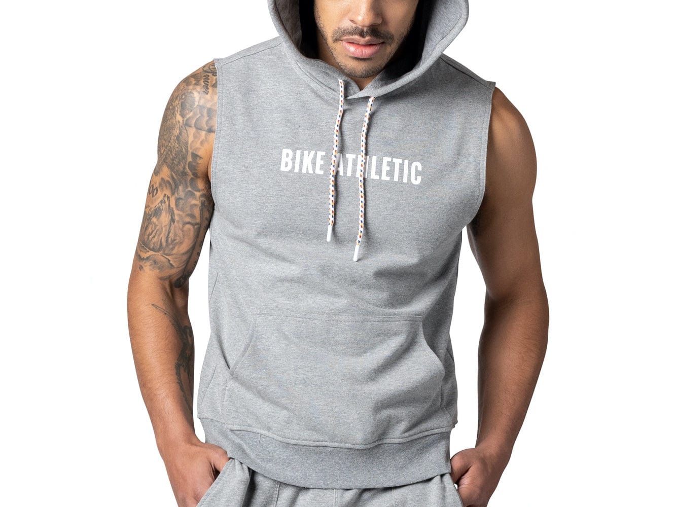Man wearing grey sleeveless BIKE® hoodie